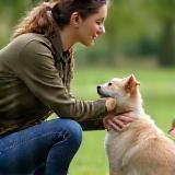Certified trainer guiding a puppy and owner